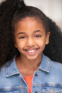 Kayla-Mai Alvares as Advertisement Girl in Barbie (07/2023)